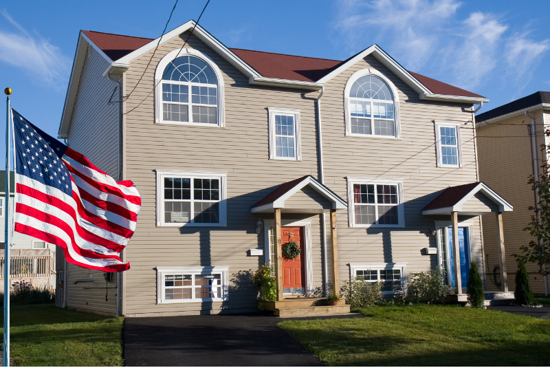 Duplex with an American flag blowing in the wind