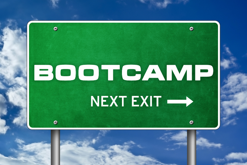 Road sign against blue cloudy sky. Sign reads: boootcamp, next exit