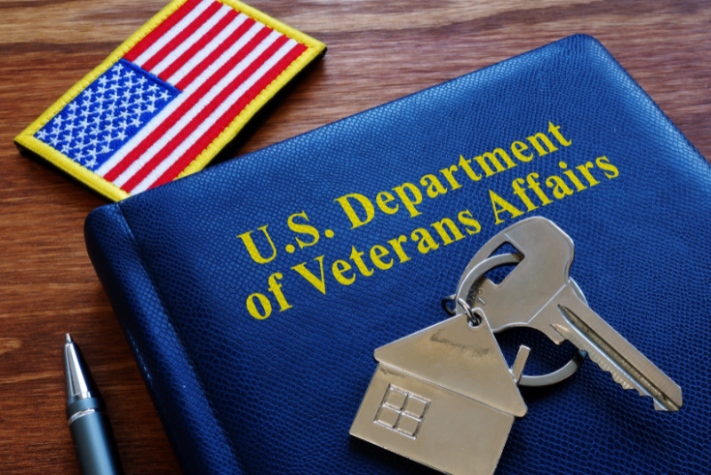 American flag, house key, blue book with title US department of veterans affairs. Blog post about veteran certificate of eligibility
